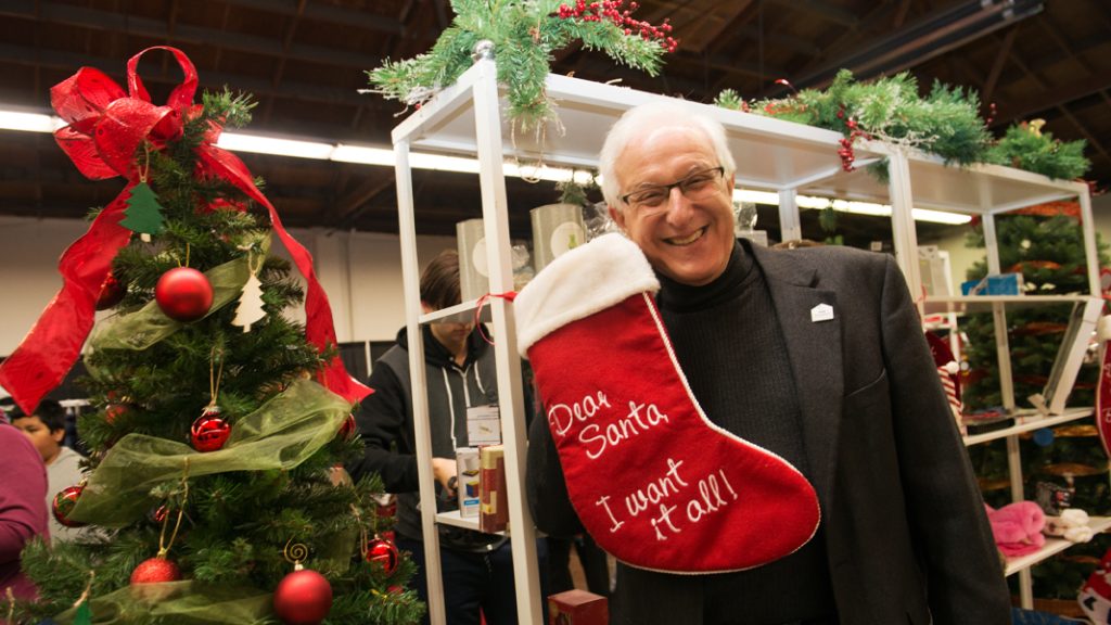 Bart with a Christmas stocking that says "Dear Santa, I want it all"