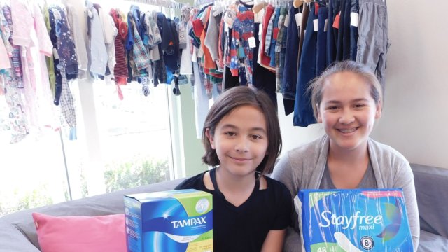 2 girls holding feminine hygiene products