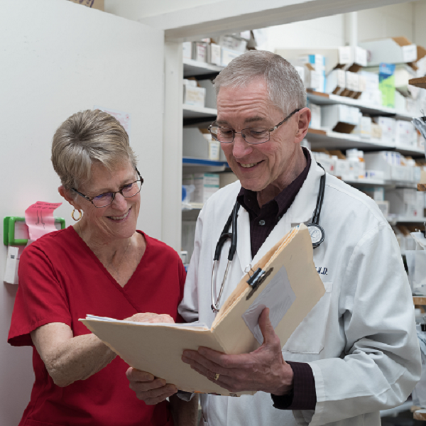 Women and doctor reviewing notes together