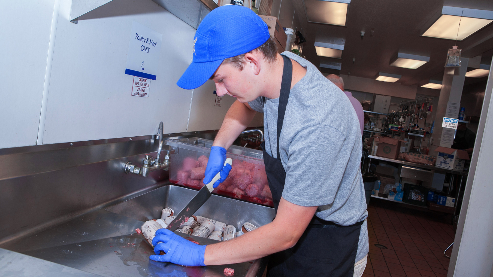 Volunteer preparing meat